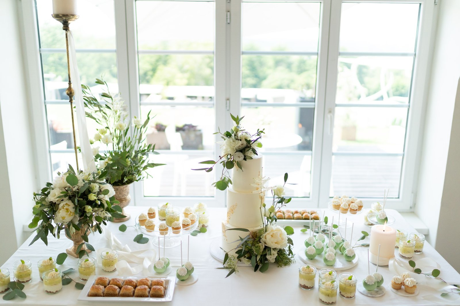 wedding-cake-cupcakes-and-sweets-on-a-nicely-decorated-event-table.jpg